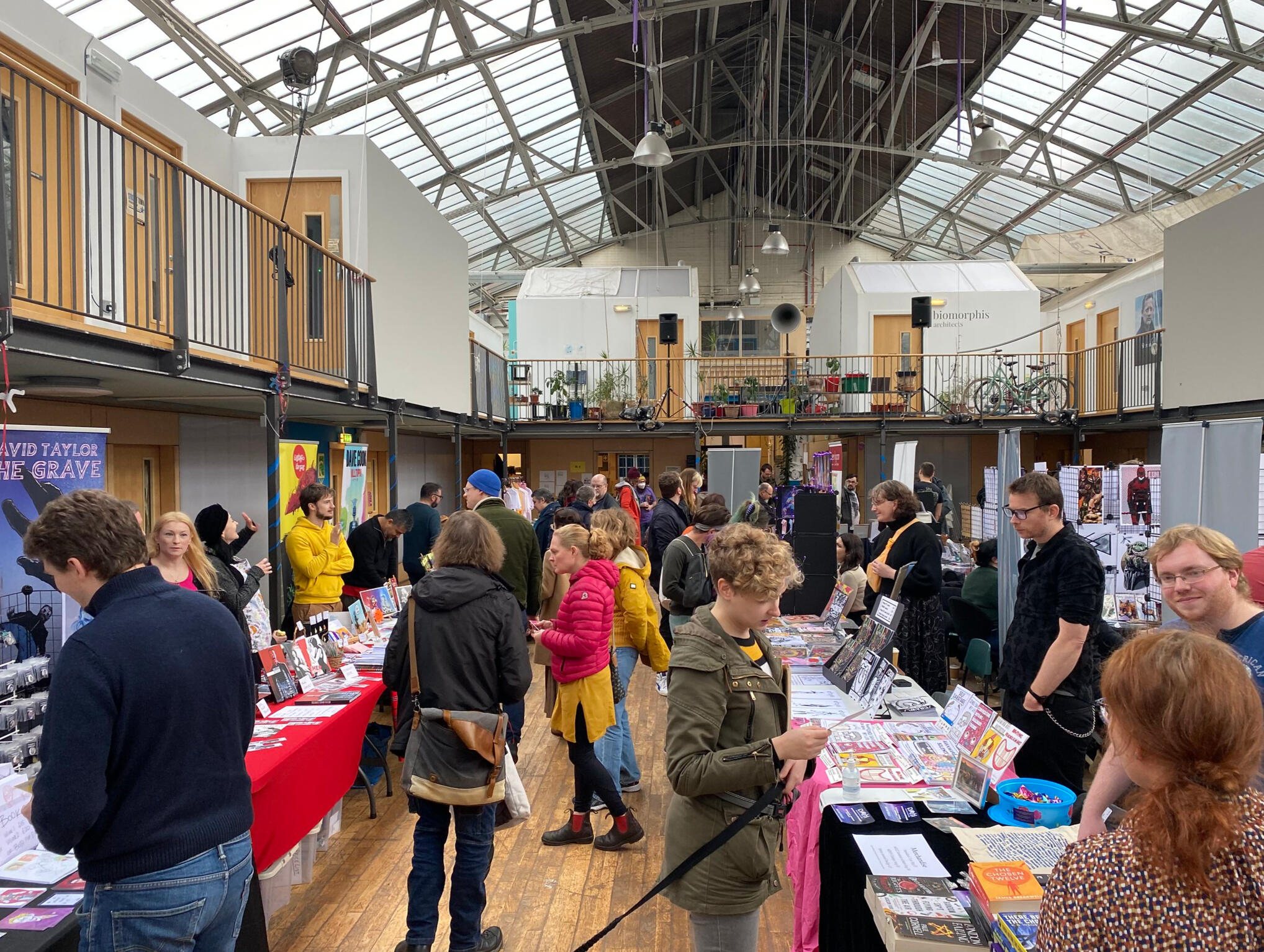 Wide photo of visitors in the Drillhall. One person has a dog with them. Wide photo of visitors in the Drillhall. One person has a dog with them.